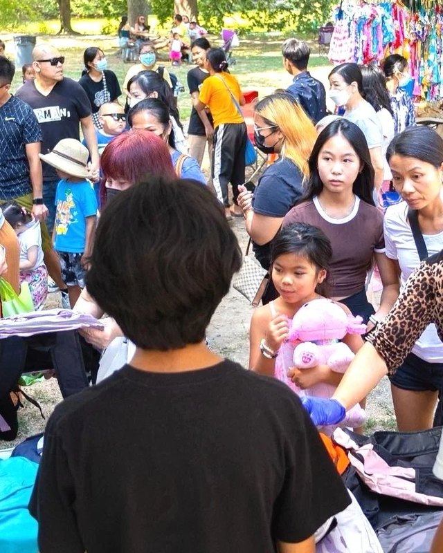 Shoppers crowd around market booths at the Southeast Asian Market in FDR Park.