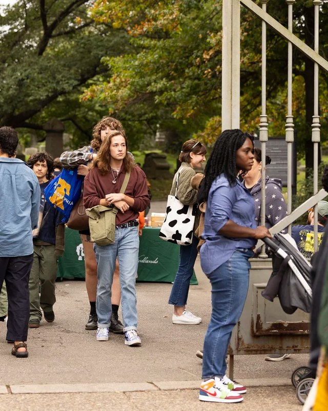 Visitors walking past vendor tables at the West Craft Fest in The Woodlands park.