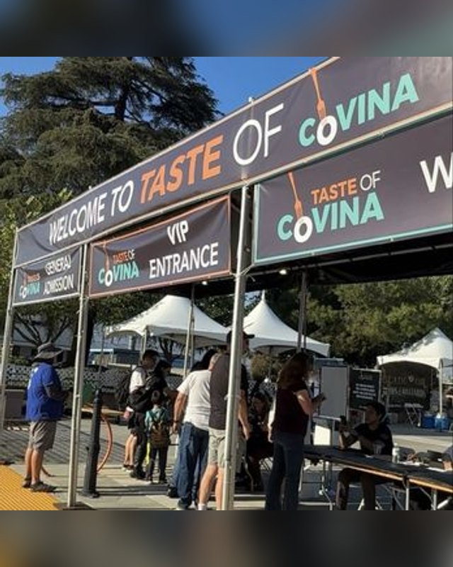 Crowd at the Welcome to Taste of Covina entrance sign with VIP gate and tents