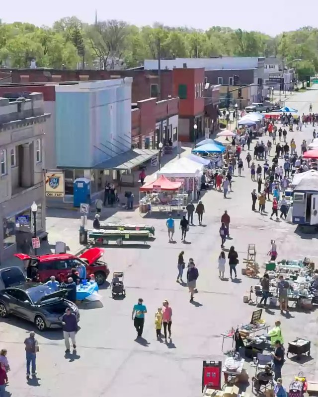 Aerial view of a downtown Wilmington street lined with market tents, vendors and shoppers.