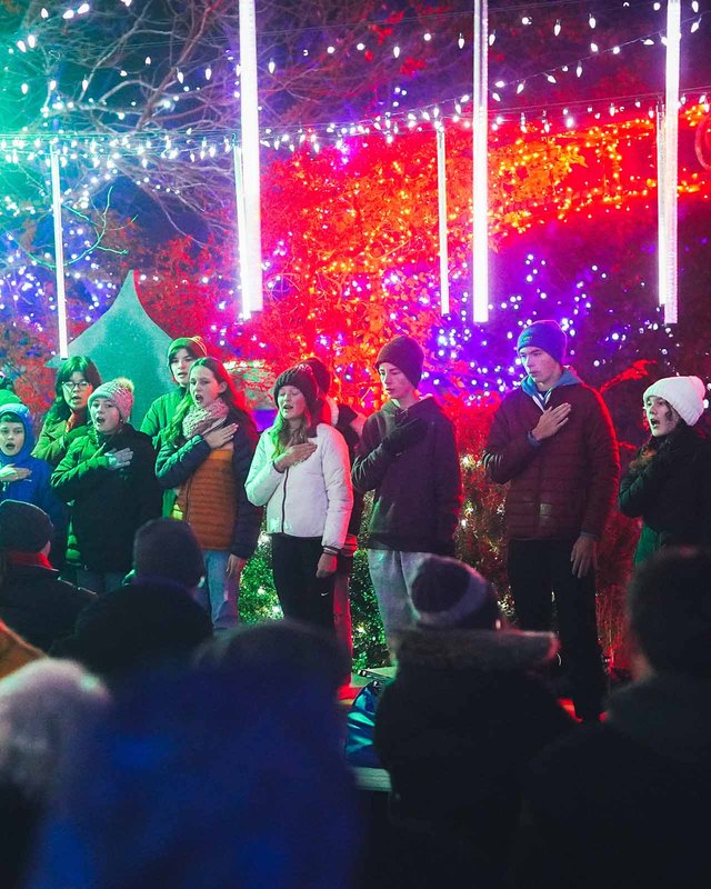 Crowd gathered in front of a red and violet light display at Winter Garden aGlow