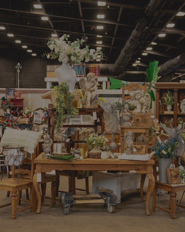 Interior of the market hall with vintage furniture, chairs and decor displayed across booths