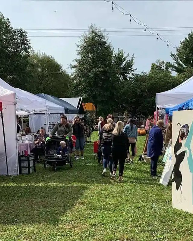 Outdoor Fall Fest vendor tents with shoppers browsing on a grass lawn at Kuchta Farms.