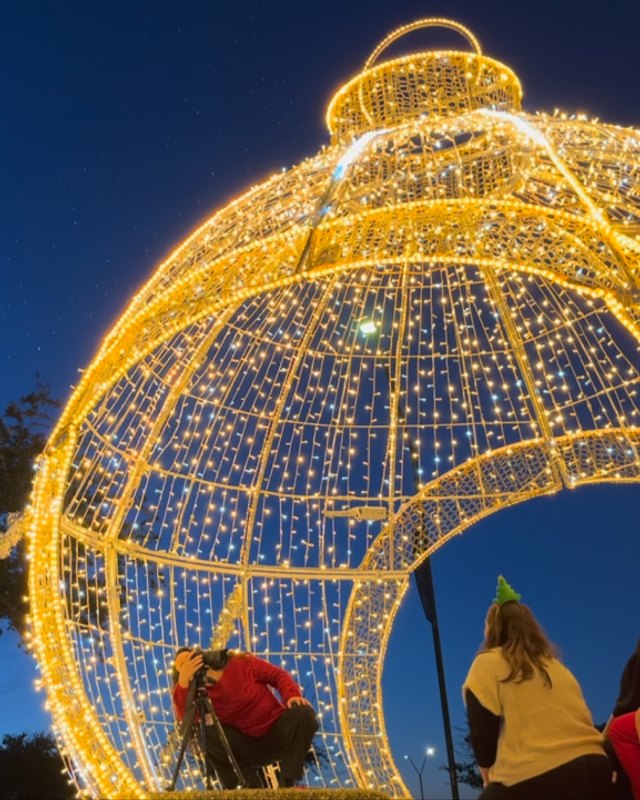 Large illuminated golden ornament sculpture with lights at dusk at Avondazzle
