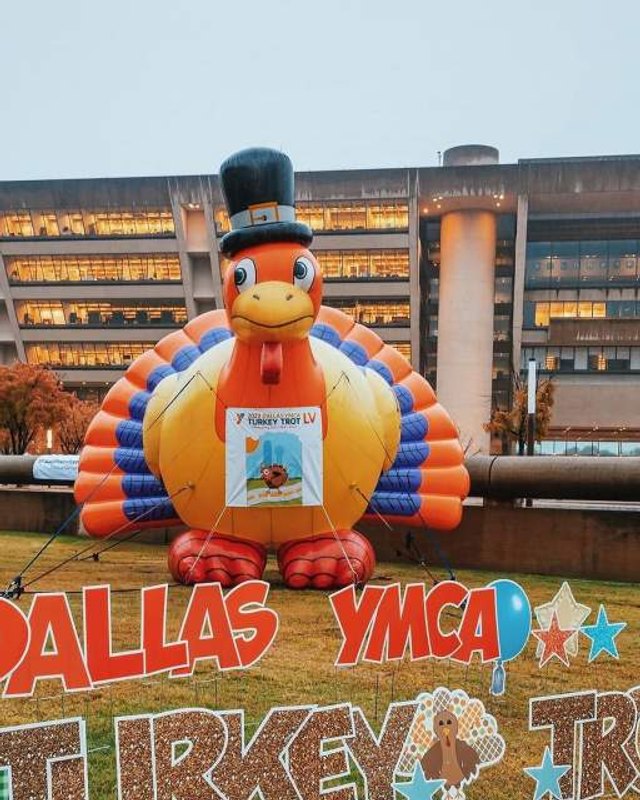 Large orange inflatable turkey mascot in front of City Hall at the Dallas YMCA Turkey Trot