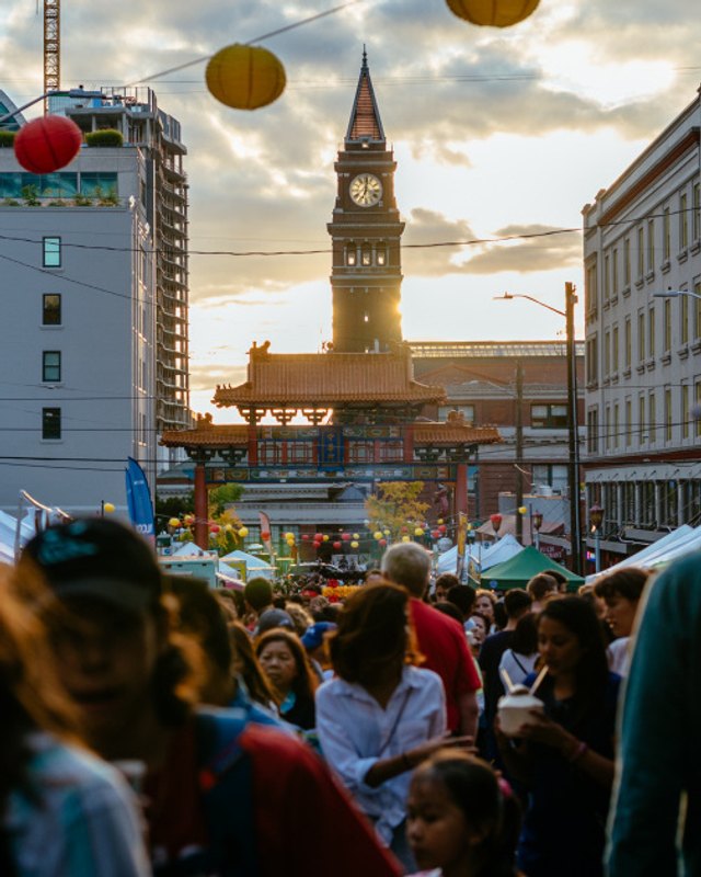 Evening crowd and food tents under string lights at the C-ID Night Market in Seattle's Chinatown-International District.