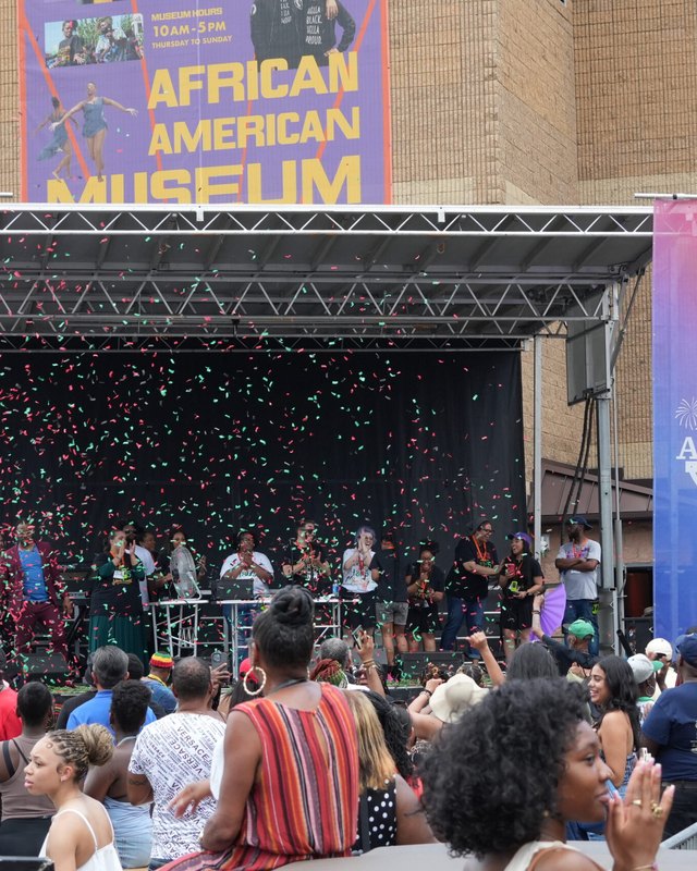Stage at the African American Museum in Philadelphia with a large outdoor crowd gathered for the Juneteenth Jubilee
