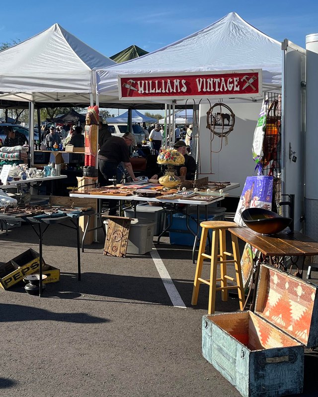 Vendor booths with vintage goods and a Williams Vintage tent at an outdoor Thieves Market