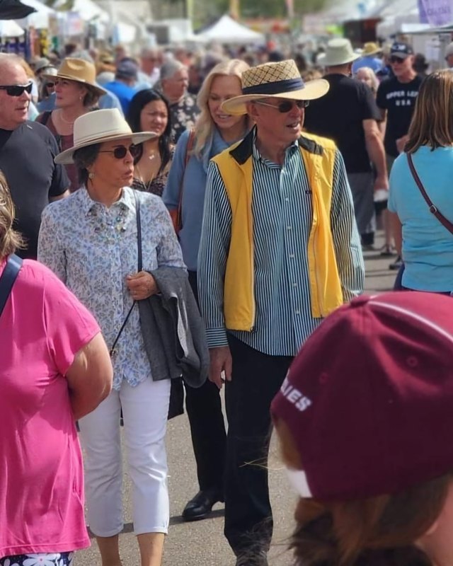 Crowd of festival visitors walking past booths at the High Street Art & Wine Festival in Phoenix.