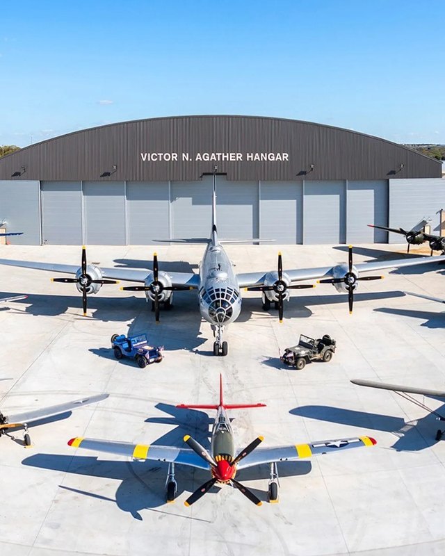 Vintage aircraft lined up on the ramp in front of the Victor N. Agather Hangar at Dallas Executive Airport