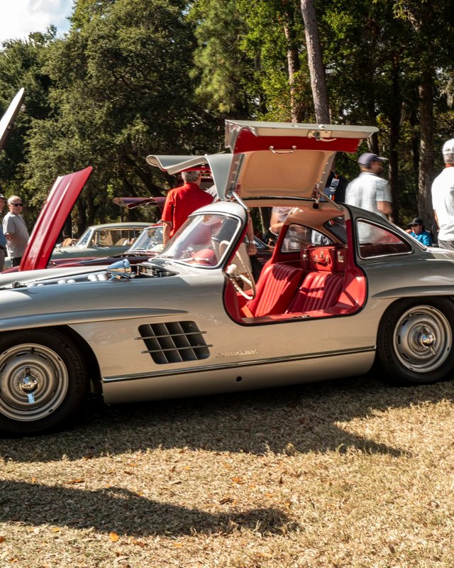 Silver gullwing sports car with open doors drawing a crowd at the Hilton Head Concours