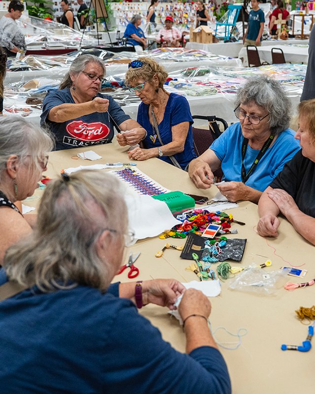 Crafters working at tables with handmade goods at the Damascus Community Fair.
