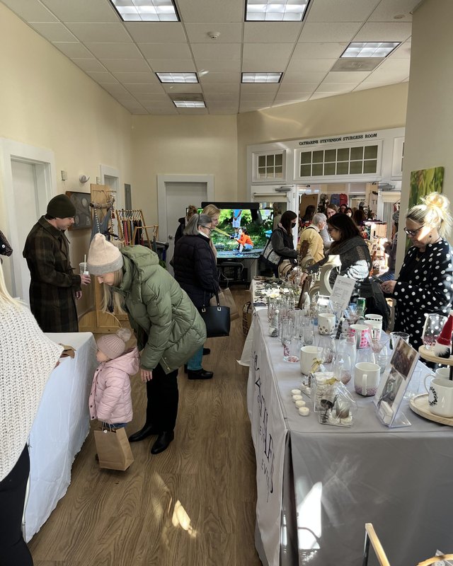 Shoppers browsing candle and craft tables at the New Canaan Nature Center Holiday Market