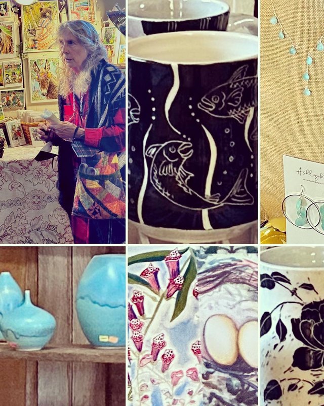 Holiday market booth with ceramics, paintings and jewelry, and a woman in a patterned top browsing
