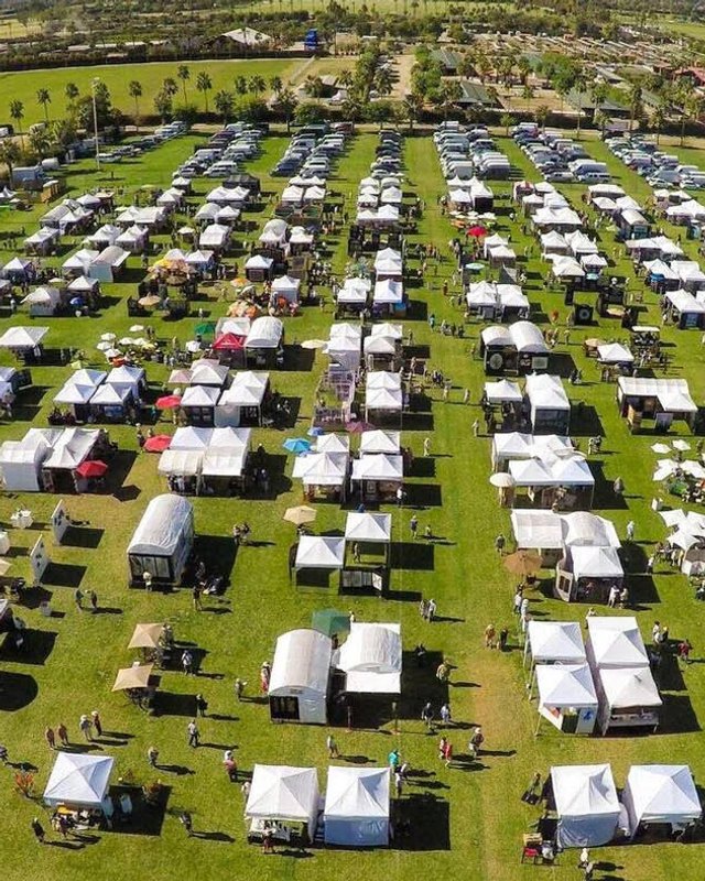 Aerial view of rows of white booth tents at the Southwest Arts Festival in Indio.