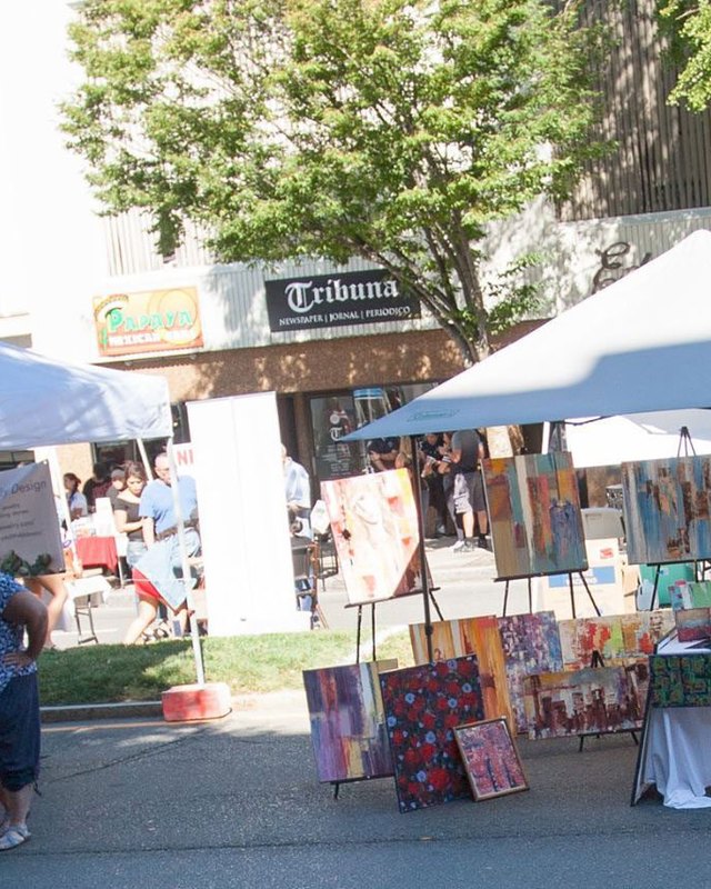 Vendor tents and shoppers along a street at the Danbury Street Festival.