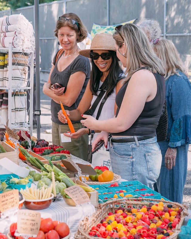 Shoppers browsing a produce and goods booth at the Renegade Craft fair in Los Angeles.