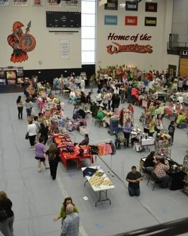 Shoppers and vendor tables set up across the Lincoln-Way West gym during the craft and vendor fair