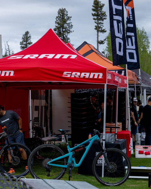 SRAM branded tent with bikes and riders at the Boise Mountain Bike Festival outdoor expo area.