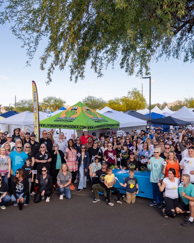 Large crowd gathered among white and colored vendor tents at an outdoor Valleypalooza market in Phoenix.